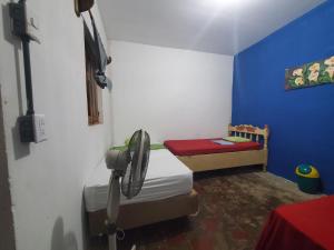 a small room with a bedroom with a bed and a table at Casa Esmeralda in Moyogalpa