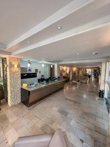 a lobby of a hotel with a reception desk at Hotel Visconde in Sobral