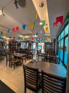 a restaurant with tables and chairs and flags on the ceiling at Hotel Visconde in Sobral
