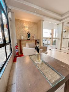 een woonkamer met een tafel en een bank bij Hotel Visconde in Sobral