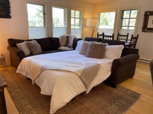 a large bed in a living room with a couch at Premier Downtown Telluride Condo with Pool, Hot Tub & Parking in Telluride