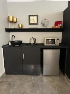 a kitchen with a counter with a microwave on it at 12 Calderbank in Potchefstroom