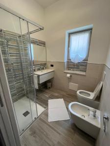 a bathroom with a shower and a sink and a toilet at MaLuNa in Castelsardo
