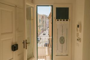 an open door to a balcony with a view of a city at Suite Sabean by STHEY in Monopoli