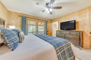 a bedroom with a bed and a flat screen tv at Cloudcroft Mountain Retreat about 5 Mi to Skiing! in Cloudcroft