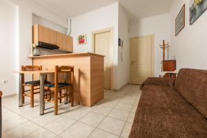 a kitchen and living room with a couch and a table at Central Cozy Apartment 4 in Sparti