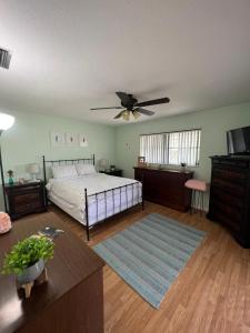 a bedroom with a bed and a ceiling fan at Super Comfy " Arcade" Home in Cape Coral, Great Location! in Cape Coral