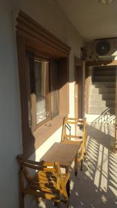 a wooden table and chairs on the porch of a house at İzol Apart Evleri Adrasan in Kumluca