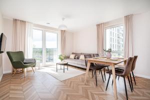 a living room with a table and a couch at Apartments 7vakarai with free parking in Vilnius