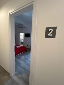 a room with a bedroom with a door with the number two at MaLuNa in Castelsardo +21 photos