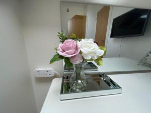 a vase filled with flowers sitting on a table at The Top Floor in Stretham