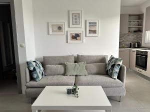 a living room with a couch and a table at MINT Novalja Apartments in Novalja