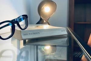 a pair of glasses sitting on top of a book at Palestro 8_Art Holiday House in Caramanico Terme