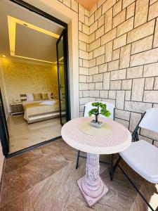 a table and chairs in a room with a bedroom at Luxury Villa Ulcinj in Ulcinj