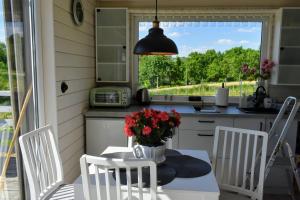 a kitchen with a table with a vase of flowers on it at Domek na Winnicy Zagrabie in Rybna