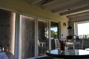 a screened in porch with a table and chairs at Domek na Winnicy Zagrabie in Rybna