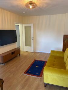 a living room with a couch and a flat screen tv at FeWo Ibis in Bottrop