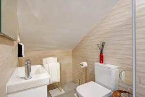 a bathroom with a white toilet and a sink at Comeback LA CASA DEL SOL NACIENTE in Salobreña +29 photos