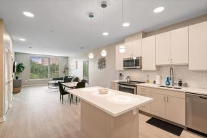 a kitchen with white cabinets and a dining room at Cityscape Haven Views Close to DC in Arlington