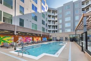 a swimming pool in the courtyard of a building at Cityscape Haven Views Close to DC in Arlington