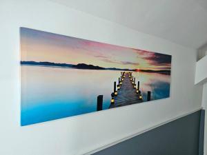 a painting of a dock on a lake at Private retreat for 3 Near Arndale City Centre in Manchester