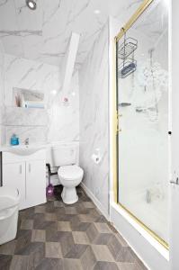 a white bathroom with a toilet and a shower at Private retreat for 3 Near Arndale City Centre in Manchester