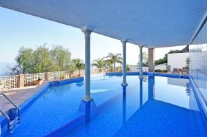 a swimming pool with blue water in a building at Comeback LA CASA DEL SOL NACIENTE in Salobreña