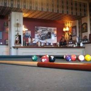 a pool table with balls on top of it at Unique Lodge in Santo Domingo