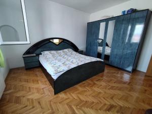 a bedroom with a bed and a large mirror at Villa Hana in Doglodi +2 photos