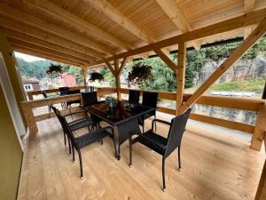 a dining room with a table and chairs at Pension Aperol in Hřensko