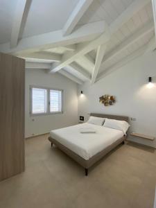 a bedroom with a large bed in a white room at Villa Lorisa in Tanaunella +35 photos