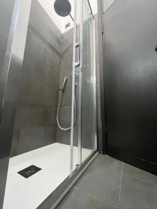 a shower with a glass door in a bathroom at Stylish Loft in Milan Mi-CoFiera-CityLife in Milan