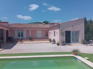 a house with a swimming pool in front of it at L’Echappée Belle in Saint-Jean-de-Fos
