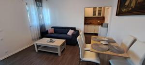 a living room with a table and a couch at Apartma Rian in Koper