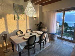 une salle à manger avec une table, des chaises et un lustre dans l'établissement Villa Montreux, à Montreux