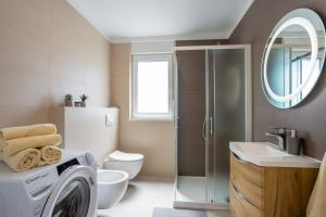 a bathroom with a washing machine and a sink at City apartments SILVER in Pula +52 photos