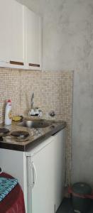a kitchen with a sink and a counter top at Terasse by the sea in Sutomore
