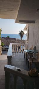 a balcony with a table and chairs and the ocean at Terasse by the sea in Sutomore