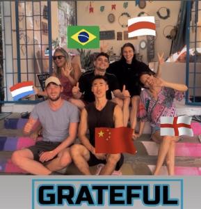 a group of people sitting on the stairs with flags at Hostel Das Canárias in Natal