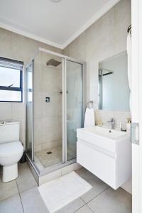 a bathroom with a shower and a toilet and a sink at Luxurious sandton apartment with Inverter in Sandton