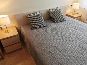a bed with two pillows on it in a bedroom at Horizon Lu Apartment by the Sea in Sopot