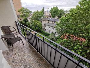 a balcony with a bench and a view of a city at Horizon Lu Apartment by the Sea in Sopot
