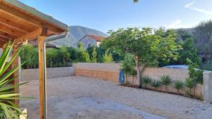 a backyard with a retaining wall and a fence at Holiday Home Leonida in Jelsa