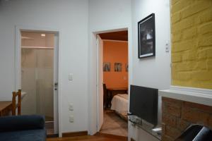 a living room with a fireplace and a television at Apartamento Kami in Porto Alegre