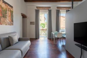 a living room with a couch and a table at Casa di Sofia Città Alta in Bergamo