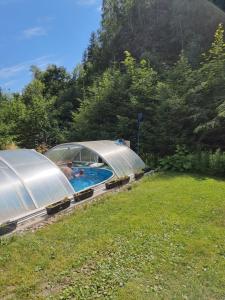 two domes in a yard with a swimming pool at Mlýn u skály in Deštné v Orlických horách