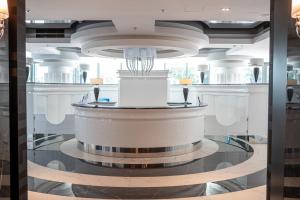 a large lobby with a large circular podium in a building at Hanza Tower Luxury in Szczecin