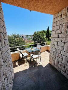 a patio with a table and chairs on a balcony at Luxury Villa Ulcinj in Ulcinj