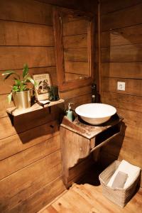 a bathroom with a sink in a wooden wall at RuralCaMomo in Cádiz