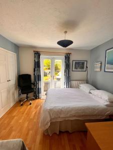 a bedroom with a bed and a chair and a window at Two double bedrooms in Paddock Wood in Paddock Wood